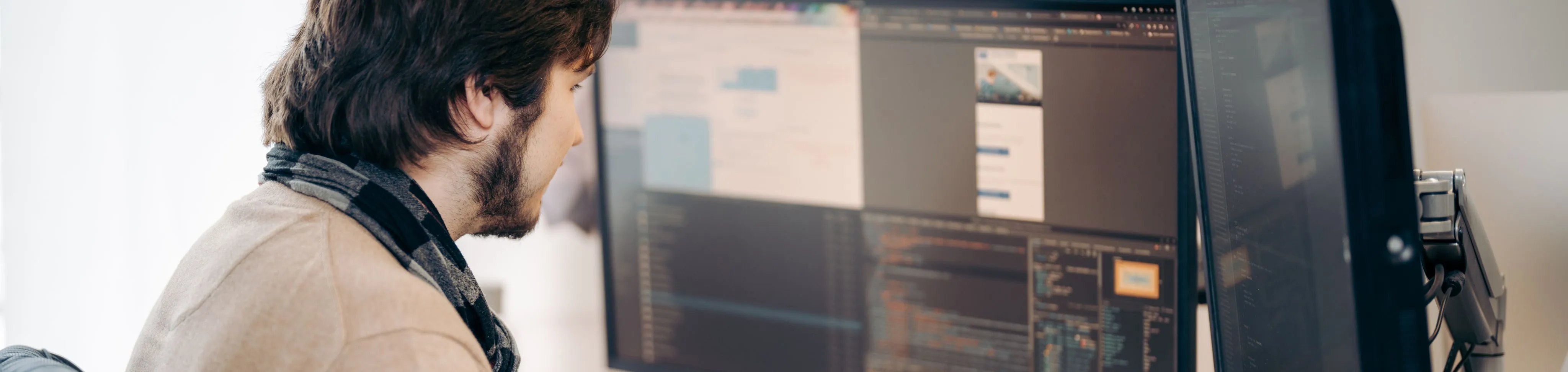 junger Mann am Arbeitspc beim Programmieren